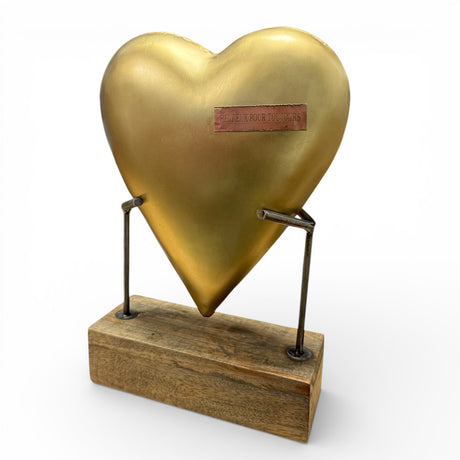 Hammered metal heart sculpture on a reclaimed wood base with French engraving reading “Happily Ever After,” tabletop decor piece by Sugarboo