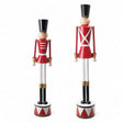 Two metal Christmas soldiers on red and white drum bases