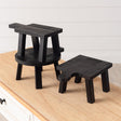 Set of three mini black wood risers in various shapes and sizes with a distressed finish