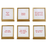 Six square gold metal and glass easel frames with red seasonal sayings on cream backgrounds.