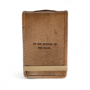 Mini leather journal with “It Was Written in the Stars” quote and elastic band closure