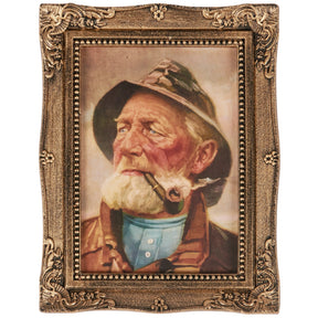 Framed wall art of old fisherman with pipe in ornate gold frame