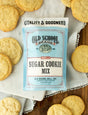 Old School Brand Vanilla Sugar Cookie Mix pouch with baked cookies on holiday plate