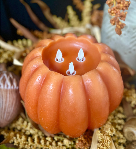 Orange pumpkin LED candle with three moving flame wicks and timer function