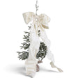  Oversized cream velvet bow with wide loops, long flowing tails, and a Velcro closure, styled on a Christmas tree.