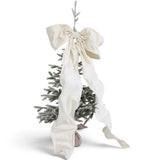 Oversized cream velvet bow with wide loops, long flowing tails, and a Velcro closure, styled on a Christmas tree.