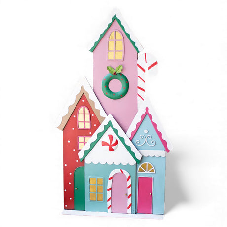 Colorful painted metal Christmas village with candy-themed houses and holiday details