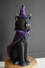 Painted resin black cat wearing a purple witch hat and cape