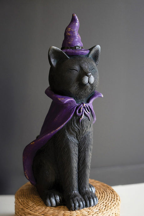 Painted resin black cat wearing a purple witch hat and cape