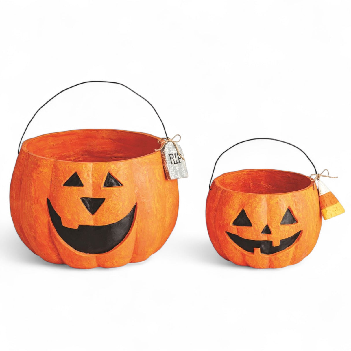 Two paper mache jack-o'-lantern treat buckets with wire handles and Halloween tags