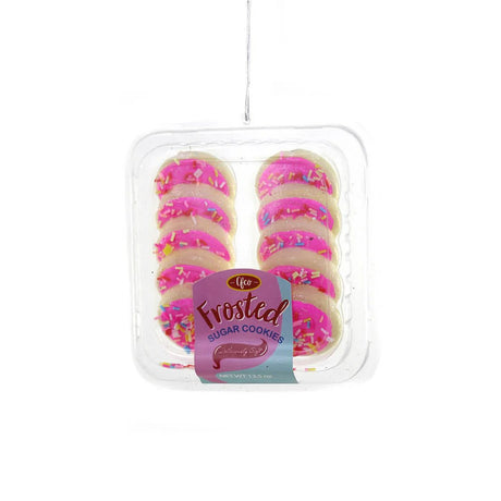 Pink frosted sugar cookies ornament with colorful sprinkles in clear tray