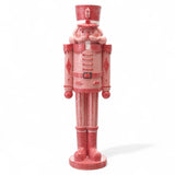 Pink and red resin nutcracker figurine with sugar finish