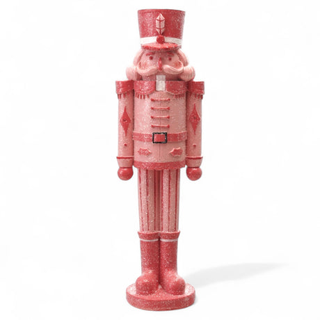 Pink and red resin nutcracker figurine with sugar finish
