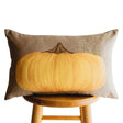 Primitive yellow pumpkin lumbar throw pillow with vintage distressed artwork on a neutral background