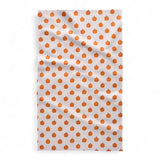 Tea towel with orange pumpkin pattern on a white background