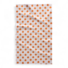 Tea towel with orange pumpkin pattern on a white background