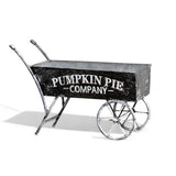 Black metal decorative wheelbarrow with “Pumpkin Pie Company” text for farmhouse fall décor