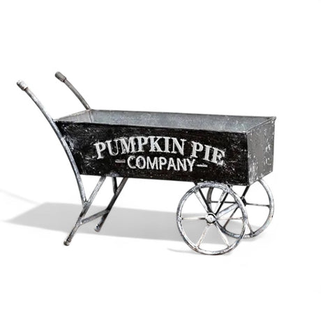 Black metal decorative wheelbarrow with “Pumpkin Pie Company” text for farmhouse fall décor