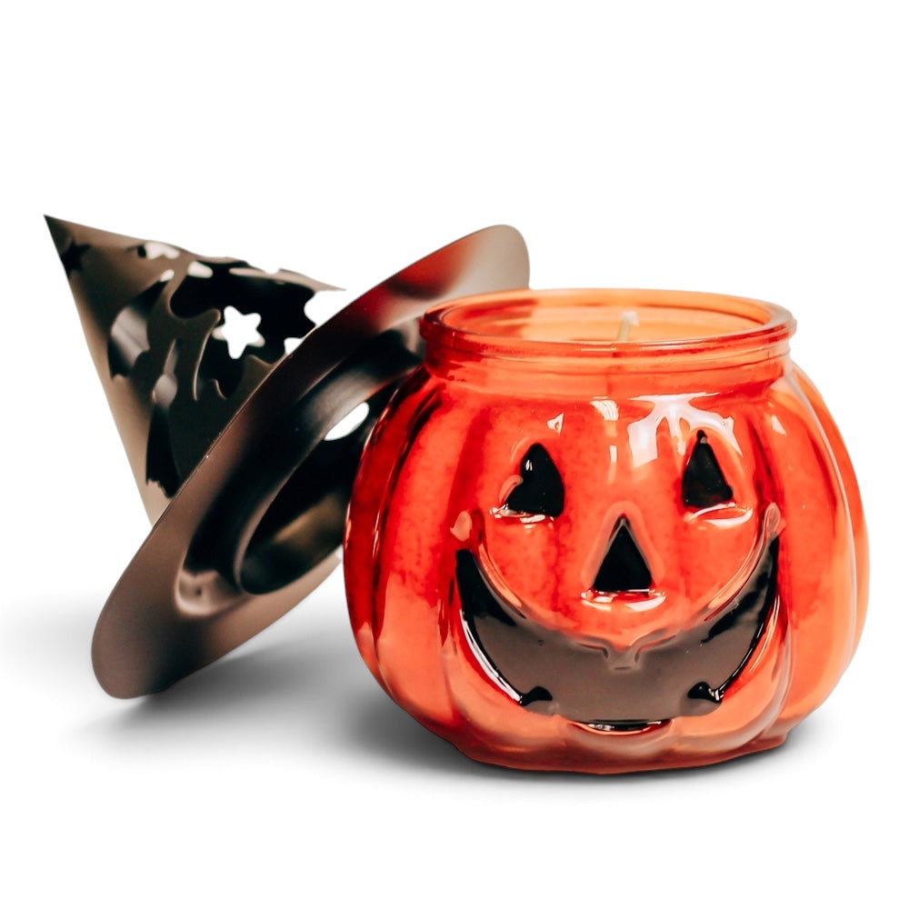 Pumpkin pie Halloween candle in orange jack-o-lantern glass jar with witch hat lid