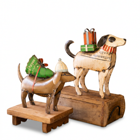 Handcrafted recycled metal Christmas dog decorations carrying gifts and Christmas tree for rustic holiday home décor.