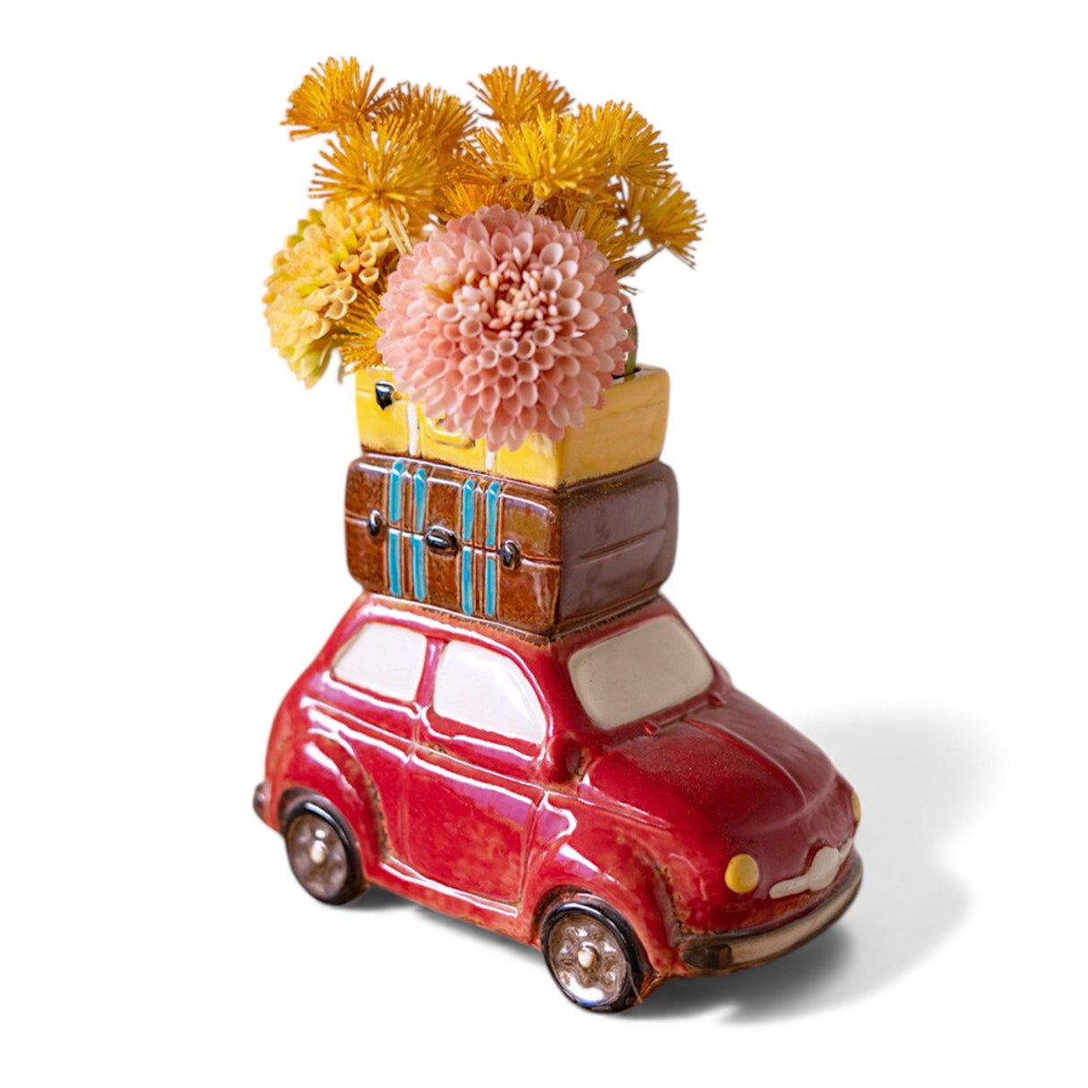 Red ceramic car planter with stacked luggage on top