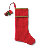 Red quilted cotton velvet Christmas stocking with green cuff trim, three decorative tassels, and a red hanging loop