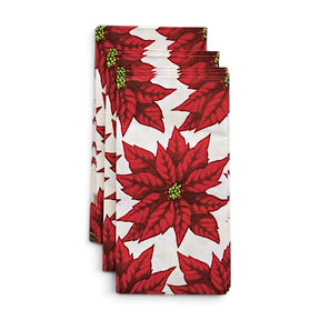 Cream paper napkins printed with red poinsettias and green centers, shown packaged beside a view of the repeating floral pattern
