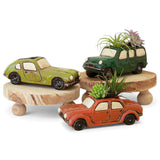 vintage-style ceramic car planters in orange, green, and forest holding small succulents