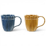 Ruffled edge ceramic coffee mugs in blue and mustard yellow with glossy textured finish