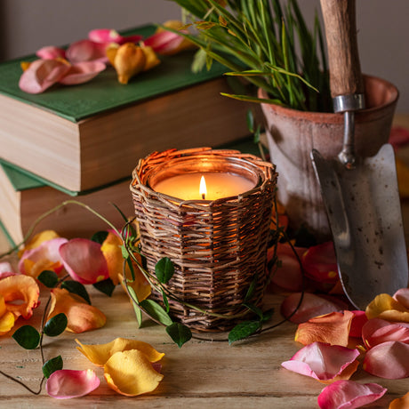 Screen Porch candle with fresh floral and cut grass fragrance in decorative woven willow candle vessel