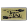 Embossed metal Halloween wall décor with witch brooms and The Season of the Sticks phrase