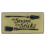 Embossed metal Halloween wall décor with witch brooms and The Season of the Sticks phrase