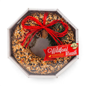 Round 9-inch bird feeding wreath made from solid seed, nuts, and fruit, presented in a shrink-wrapped tray.