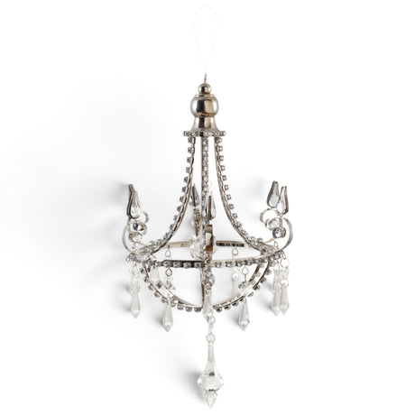 Silver metal chandelier ornament with curved scrollwork, clear acrylic jewels, and dangling faceted pendants.