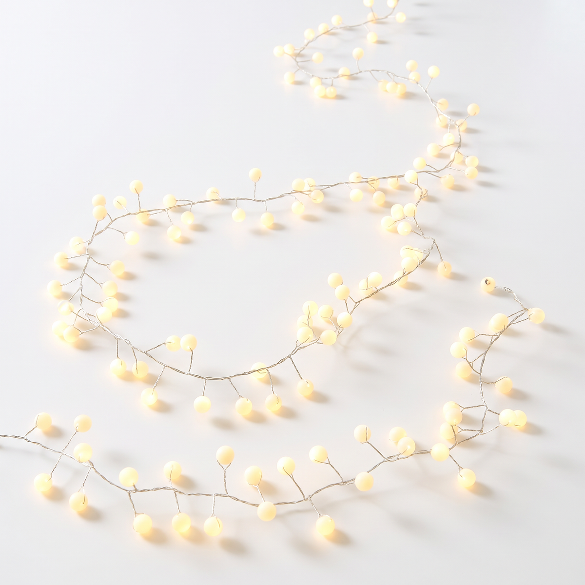 Snowberry plug-in decorative lights with 200 warm white LEDs for indoor and outdoor holiday displays.