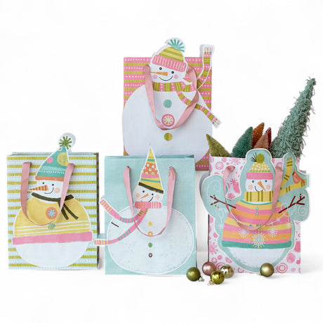 recycled paper gift bags with snowman designs and satin handles in assorted pastel winter colors.
