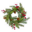 A Christmas candle ring with spruce and red berries