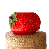 Faux concrete strawberry stool with a vibrant red finish, ideal for seating or decor.