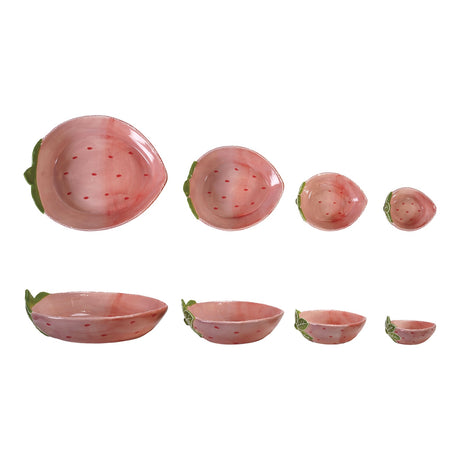 Set of four hand-painted strawberry-shaped stoneware nesting bowls in pink and red with green leaf accents.