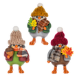 Three fall bird figurines in knit hats and scarves, each holding autumn accessories