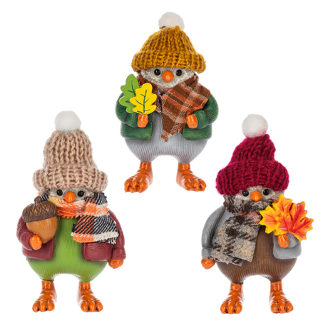 Three fall bird figurines in knit hats and scarves, each holding autumn accessories