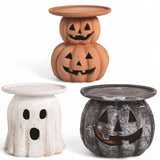 Three terracotta Halloween candle holders in pumpkin, ghost, and black jack-o'-lantern designs, each with a flat top for candles.