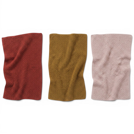 Textured cotton knit tea towels in rust, mustard, and oatmeal
