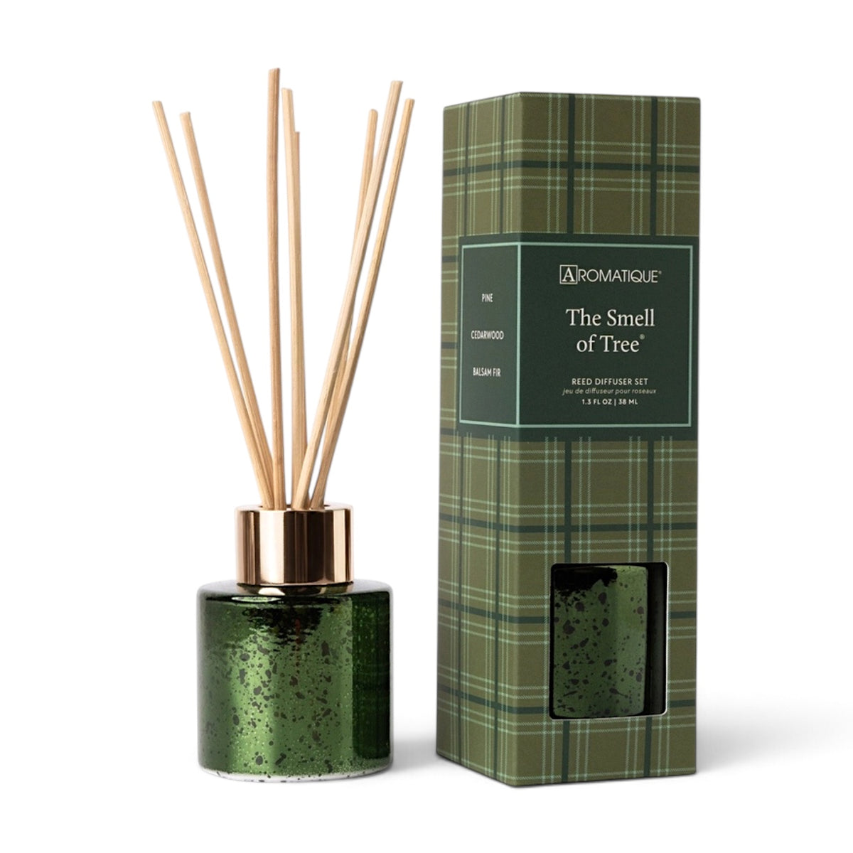 The Smell of Tree mini reed diffuser in speckled green metallic glass with a gold-tone collar, natural reeds, and green plaid gift box