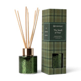 The Smell of Tree mini reed diffuser in speckled green metallic glass with a gold-tone collar, natural reeds, and green plaid gift box