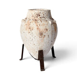 Tuscan style concrete planter with distressed finish and three leg iron stand
