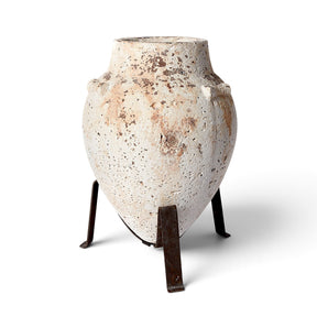 Tuscan style concrete planter with distressed finish and three leg iron stand