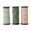 Three velvet ribbons with gold edges on wooden spools in mint, forest green, and blush pink