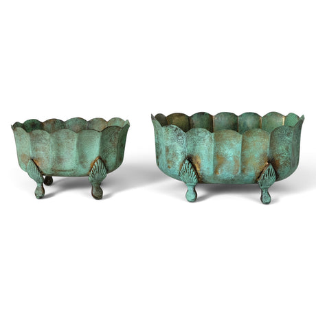 Two oval metal planters with scalloped rims, decorative feet, and mottled turquoise green and bronze verdigris finish
