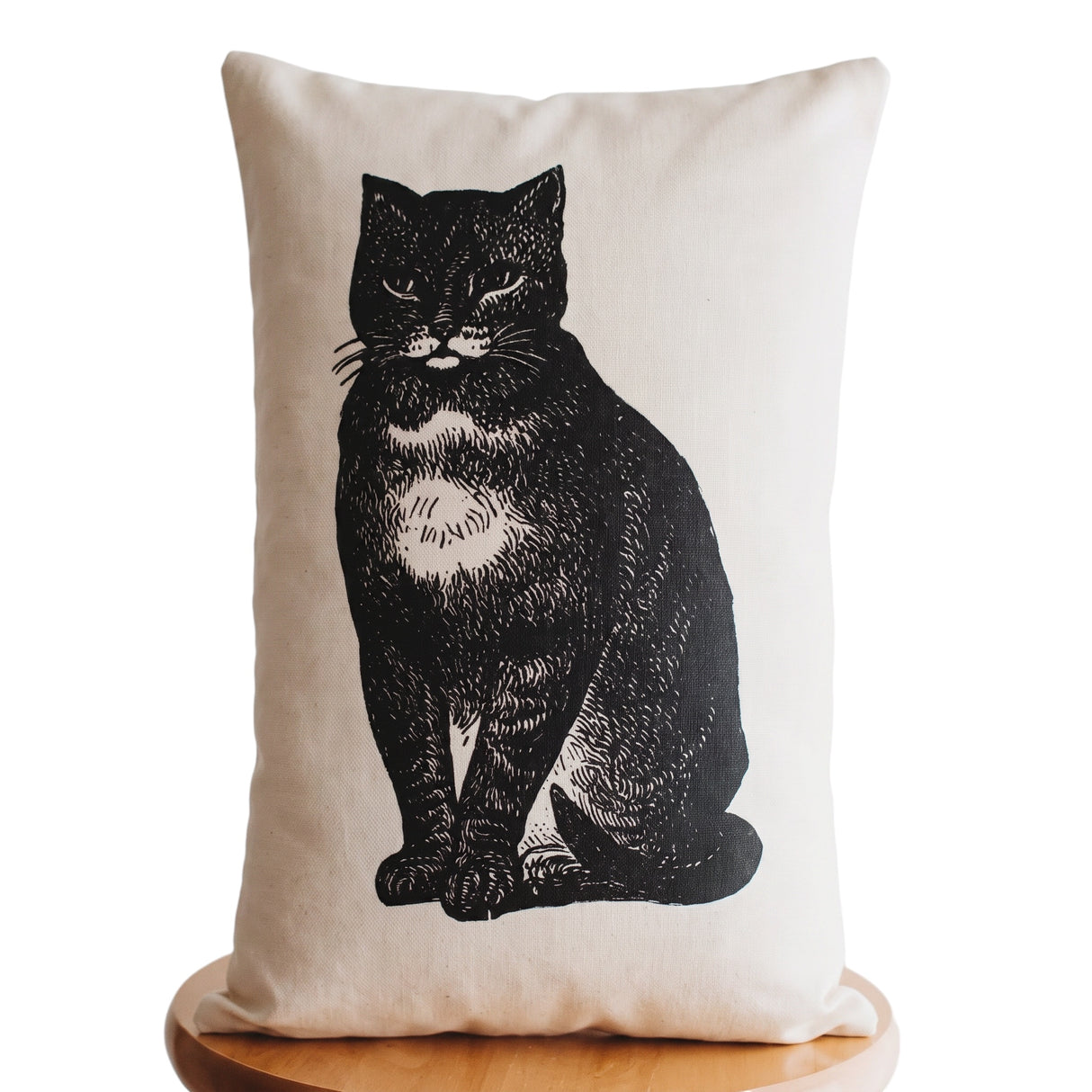 Vintage black cat lumbar throw pillow with distressed illustration on a neutral background